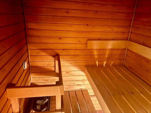 a small wooden sauna with a bench in it at Nordic Sauna Experience in Helsinki