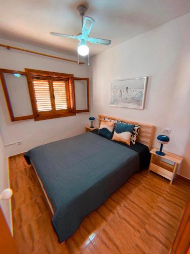 a bedroom with a bed and a ceiling fan at Blue Vibes, Relax & Beach in San Javier