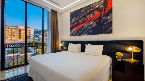 a bedroom with a white bed and a large window at PIER 57 - 710 Fabulous & Luxurious 2 BR Penthouse in Puerto Vallarta