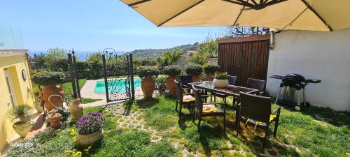 a patio with an umbrella and a table and chairs at Villa Caruso in Massa Lubrense
