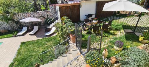 a patio with a table and chairs and an umbrella at Villa Caruso in Massa Lubrense