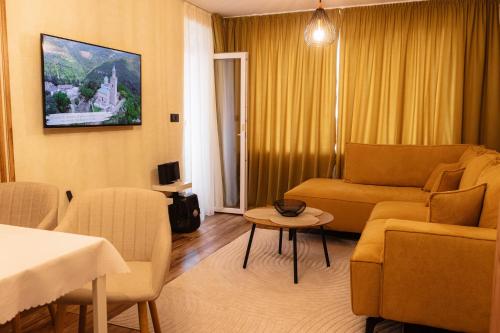 a living room with a couch and a table at Tirol Home - Apartment in Veliko Tŭrnovo