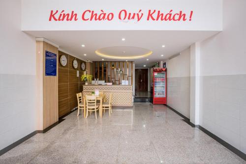 a restaurant with a table and chairs in a hallway at P Xuân Quy Nhơn Hotel in Quy Nhon