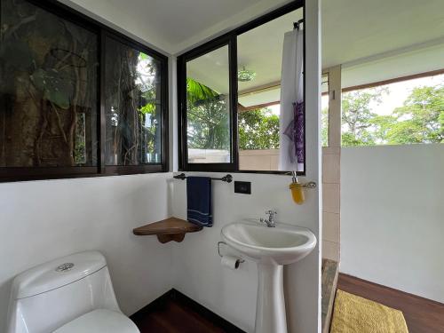 a bathroom with a toilet and a sink at Ka Namu in Puerto Viejo
