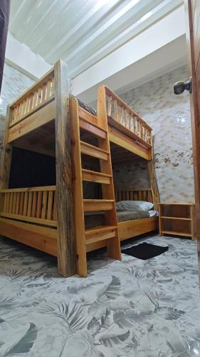 two bunk beds are in a room with aerellathritisthritisthritisthritisthritisthritis at KBC ZAI Baguio Staycation 2 in Baguio