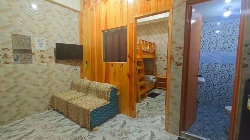a living room with a chair and a tv in a room at KBC ZAI Baguio Staycation 2 in Baguio