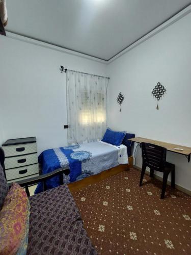 a bedroom with a bed and a desk and a table at Cozy Room & Modern Amenities 3 in Tetouan
