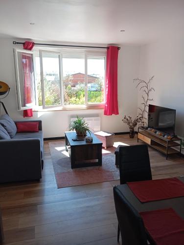 a living room with a couch and a table at T3, 2 chambres avec parking privé in Aurillac
