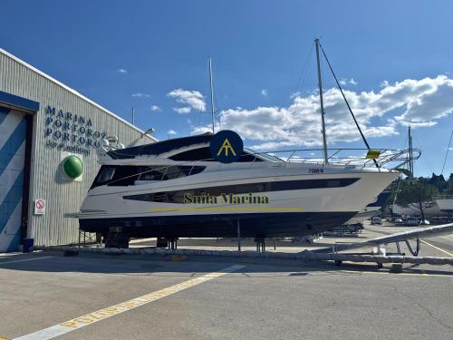 a boat is parked in front of a building at SUITA MARINA - Near Beach with Terrace & 2 Parking Spaces at Marina Portoroz in Portorož