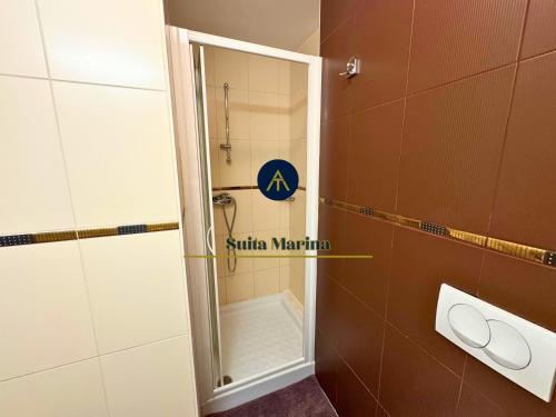 a small bathroom with a shower with a mirror at SUITA MARINA - Near Beach with Terrace & 2 Parking Spaces at Marina Portoroz in Portorož