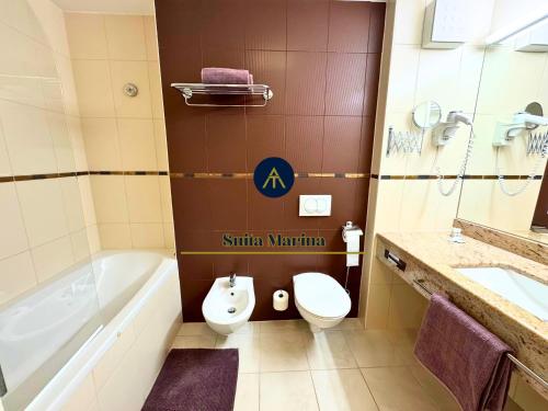 a bathroom with a tub and a toilet and a sink at SUITA MARINA - Near Beach with Terrace & 2 Parking Spaces at Marina Portoroz in Portorož