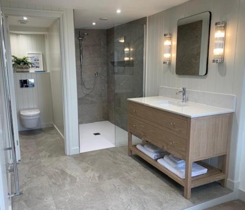 a bathroom with a sink and a shower at Tower House, Cowes Old Town in Cowes
