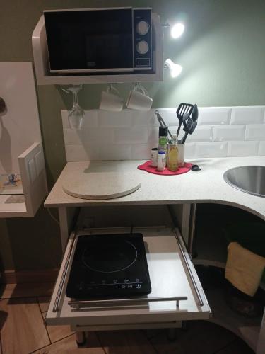 a kitchen with a counter top with a microwave at Serendipity NO TV in Polokwane
