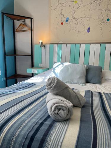 a pile of towels sitting on top of a bed at BbCasita Yellow in Valparaíso
