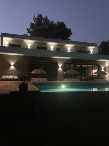 une maison avec piscine la nuit dans l'établissement Villa Brisson, à Léognan