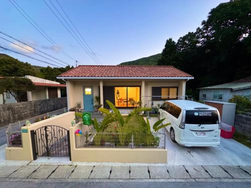 a car parked in front of a house at Cottage in Tokashiki MIUFUYA in Tokashiki