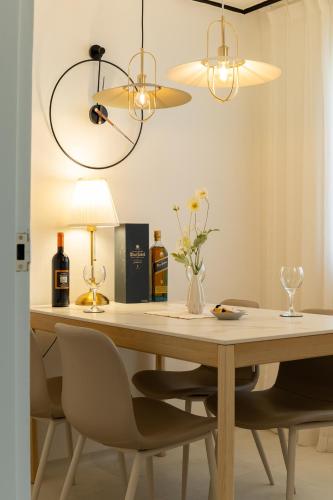 a dining room table with two bottles of wine and a lamp at Naroo Stay - DDP and Jong-ro in Seoul