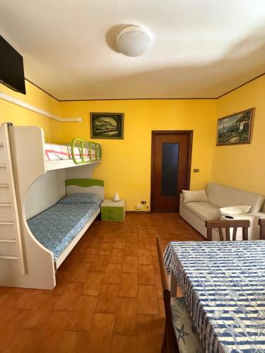 una habitación con dos literas y un sofá en La Tana del Granchio, en San Terenzo
