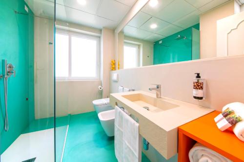 a bathroom with a sink and a toilet at Hermitage Resort & Thermal Spa in Ischia