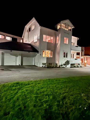 a large white house at night at Bispen Villa Utsikten in Åndalsnes