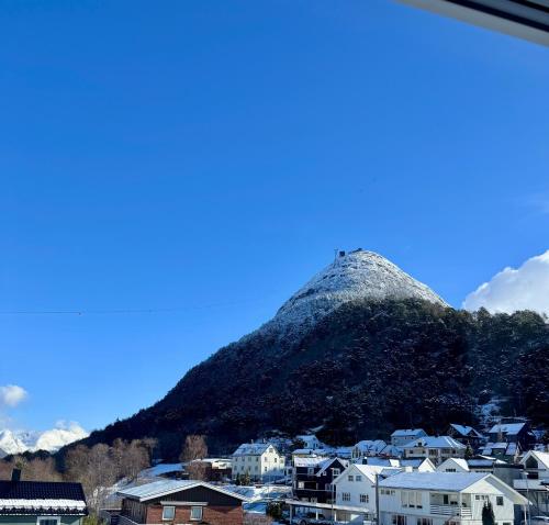 a view of a mountain with houses and buildings at Bispen Villa Utsikten in Åndalsnes