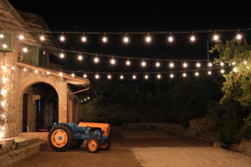 a tractor parked in front of a building with lights at Casa M Tuscany in Chianciano Terme