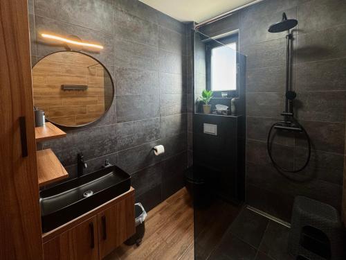 a black bathroom with a sink and a shower at Golden Sunset 3 in Njivice