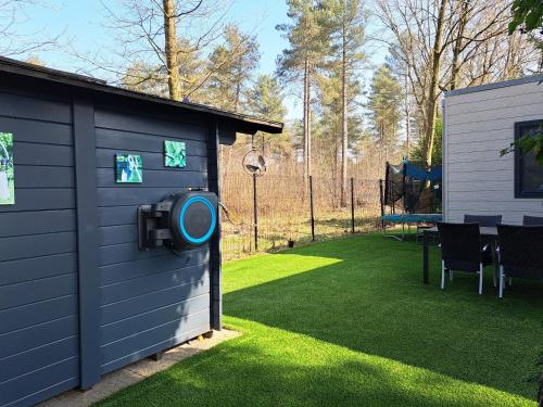 a backyard with a building with a ping pong ball at Boshuisje op de Schatberg in Sevenum