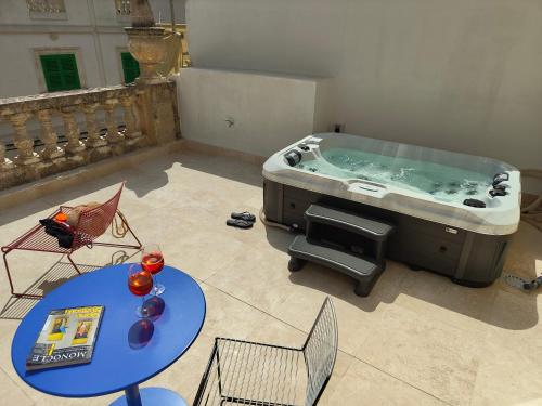 a large jacuzzi tub in a room with a table at Alba in Sliema