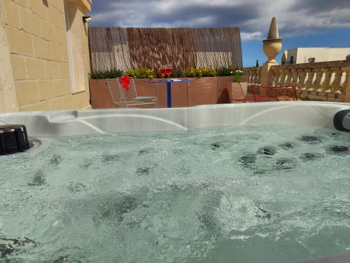 a large hot tub with water in a backyard at Alba in Sliema