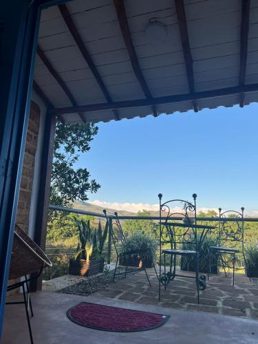 a porch with chairs and a view of the ocean at Villa Paula in Barichara