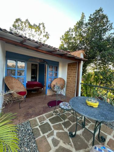 a patio with a table and chairs on a patio at Villa Paula in Barichara