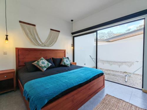 a bedroom with a bed and a large window at Blissful Homes in Huacas
