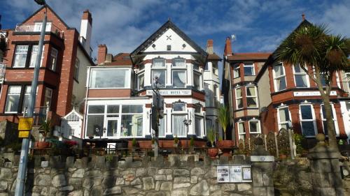 a large house with a fence in front of it at Whitehall Guest House in Colwyn Bay