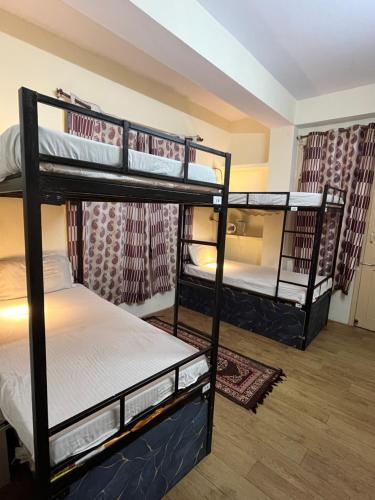 a room with three bunk beds in it at hill view hostel in Shimla