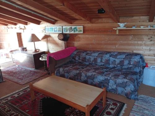 a living room with a couch and a table at Casa RMF alla Fontana in Valsolda