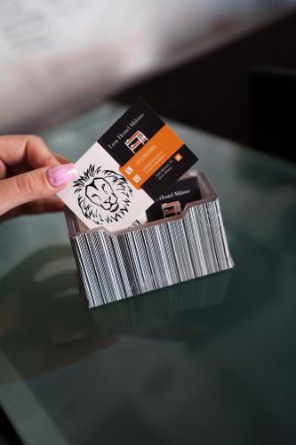 a hand holding a stack of cards on a table at Lion University & Youth Hostel Milano in Milan