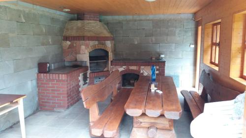 a room with a brick oven and a wooden bench at Apalucha119 in Ludvíkov