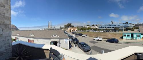 a view of a street with cars parked in a parking lot at HarborWalk Inn in Morro Bay