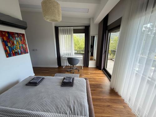 a bedroom with two beds and a large window at Canyon Villa Göynük Kemer Antalya with Pool in Antalya