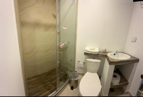 a bathroom with a shower and a toilet and a sink at apartamentos villa 1blanca in Popayan