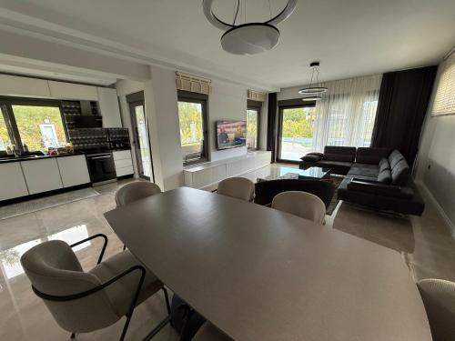 a living room with a table and chairs at Canyon Villa Göynük Kemer Antalya with Pool in Antalya