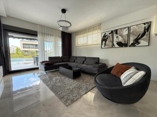 a living room with a couch and a chair at Canyon Villa Göynük Kemer Antalya with Pool in Antalya