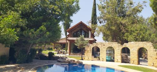 a house with a swimming pool in a yard at Stone Garden Oasis Cottage in Limassol