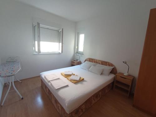 a bedroom with a bed with a tray on it at Apartment TIM Baška Voda in Baška Voda