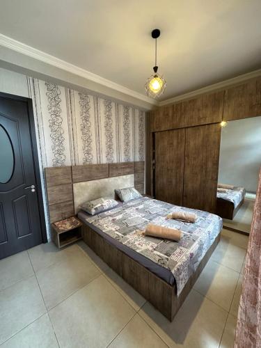 a bedroom with a bed and a blue door at Sweet Home Saburtalo in Tbilisi City