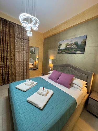 a bedroom with a blue bed with towels on it at SAARAH affittacamere in Rome
