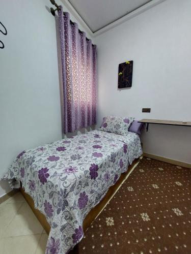 a bedroom with a bed with a purple bedspread at Cozy Room & Modern Amenities 6 in Tetouan