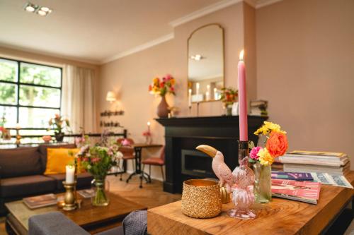 a living room with a table with a candle on it at Hotel Janssen in Valkenburg