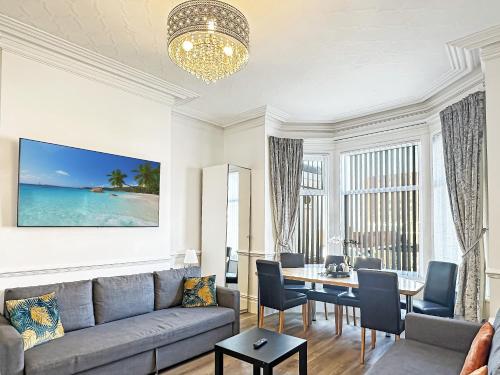 a living room with a couch and a table at Granada Apartments Derby Road in Blackpool